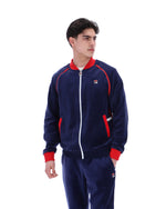 Person wearing a navy tracksuit with red accents on a white background