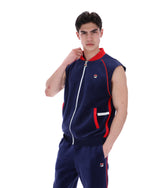 Man wearing a navy tracksuit with red accents on a white background