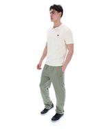 Man wearing a white polo shirt and green checkered pants on a white background
