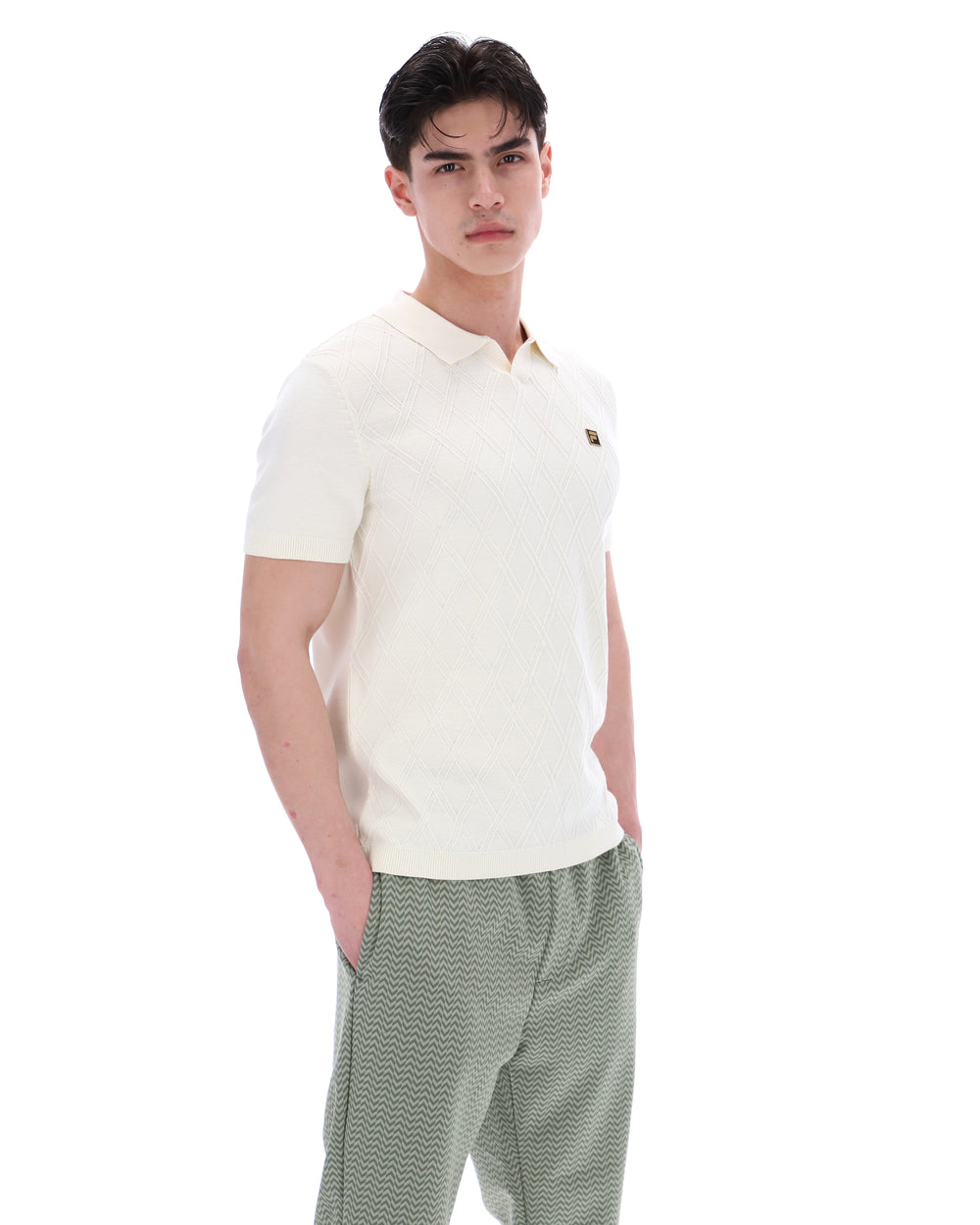 Man wearing a white polo shirt and green checkered pants on a white background