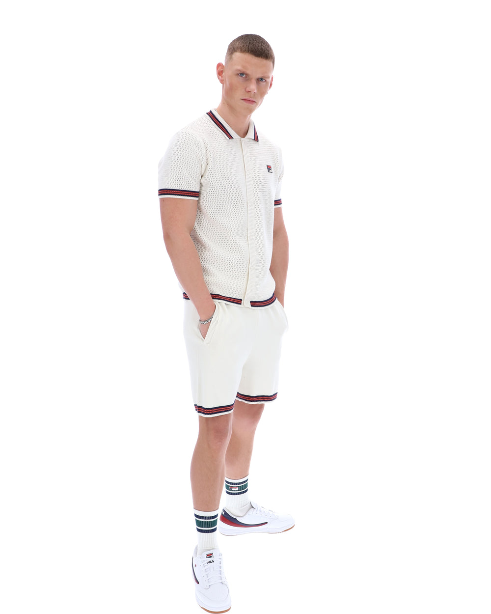 Man wearing a white outfit with red accents on a white background