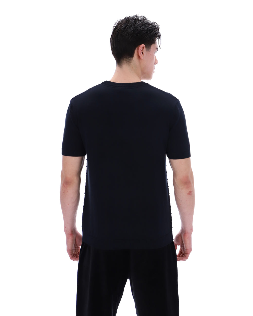 Person wearing a black t-shirt and pants on a white background