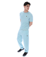 Man wearing a light blue outfit with a white background