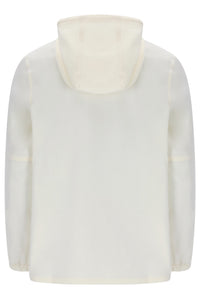 A cream-colored long-sleeve top with a high mock neck or hood, shown from the back against a plain white background.