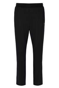 Black textured pants on a white background