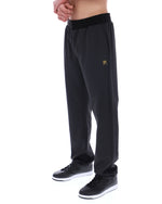 Black textured pants worn by a person on a white background
