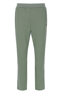 Displays a model wearing the Sea Foam 'FILA' branded Edward Herringbone Pant