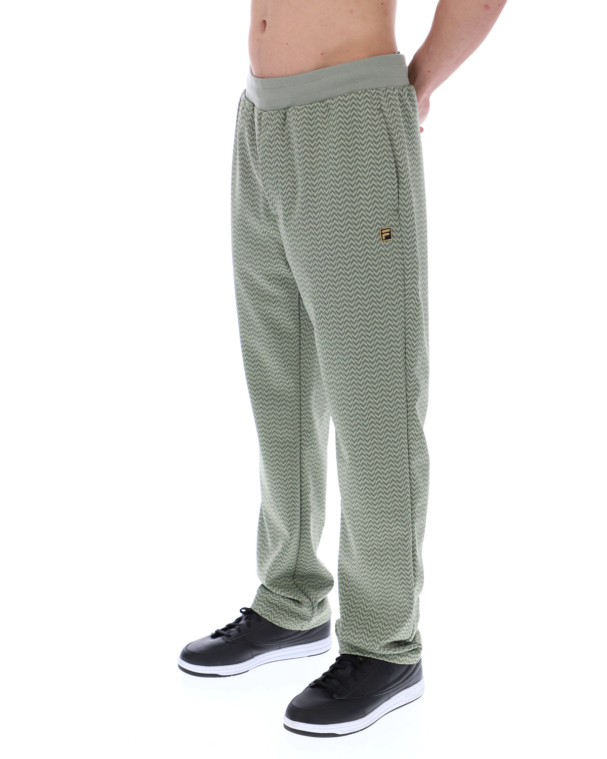 Displays a model wearing the Sea Foam 'FILA' branded Edward Herringbone Pant