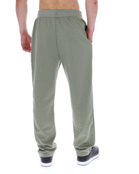 Displays a model wearing the Sea Foam 'FILA' branded Edward Herringbone Pant