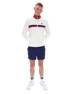 Man wearing a white sweater with red and blue stripes and navy shorts on a white background