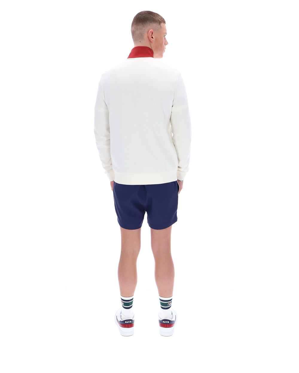 Person wearing a white sweater and blue shorts on a white background