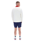 Person wearing a white sweater and blue shorts on a white background