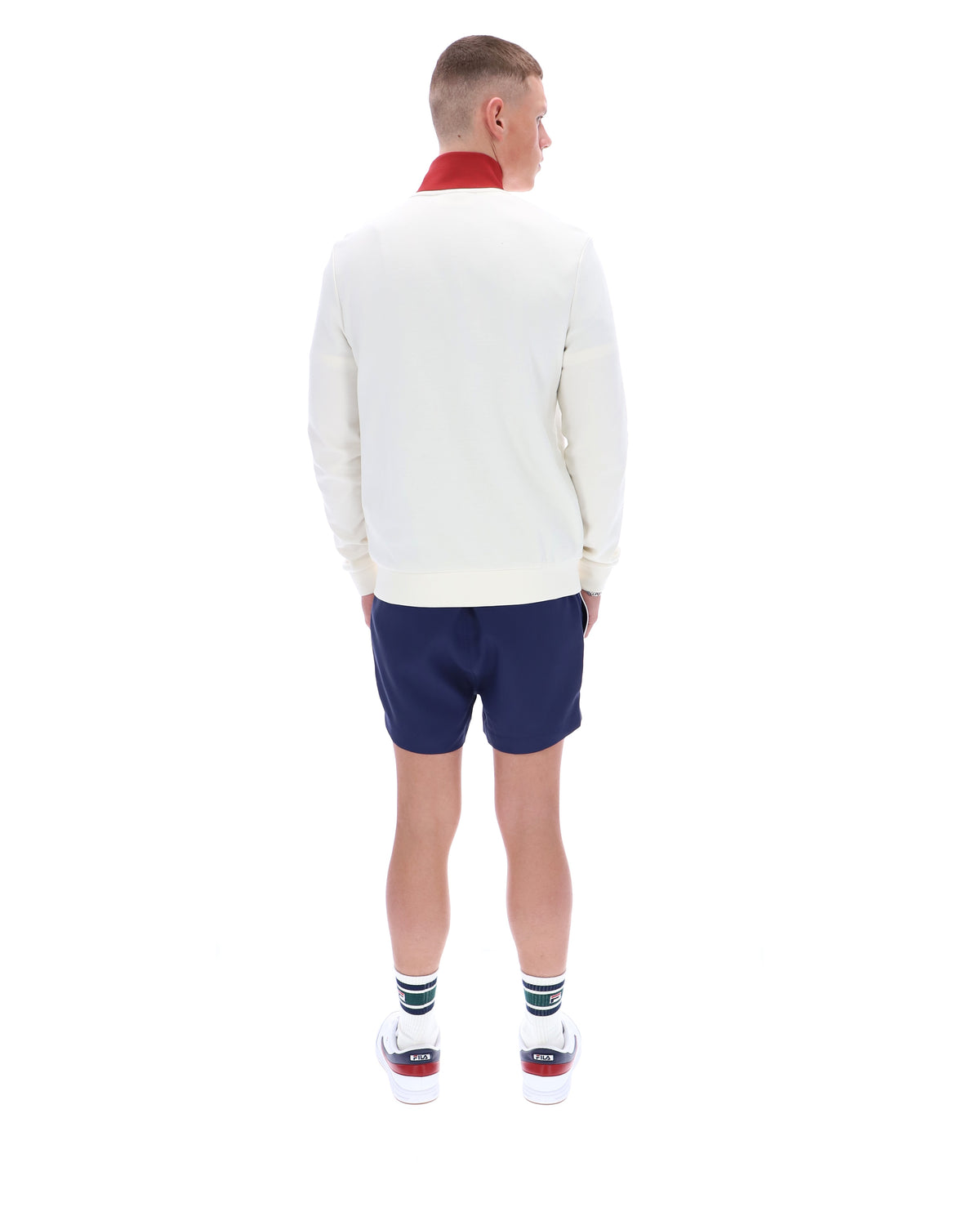 Person wearing a white sweater and blue shorts on a white background