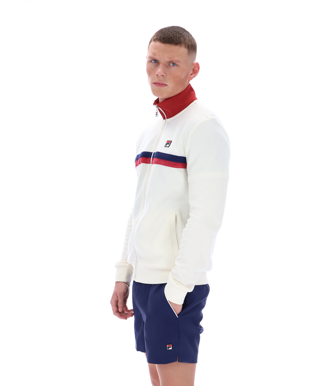 Person wearing a white tracksuit with red and blue accents on a white background
