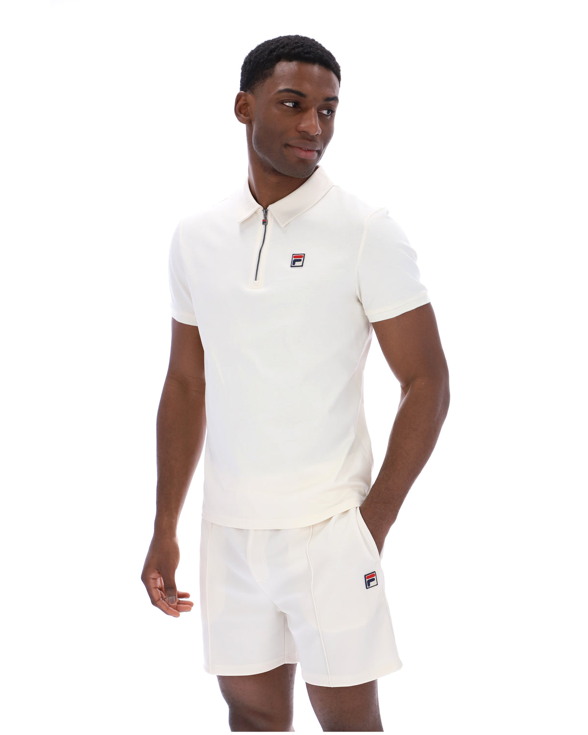Displays a model wearing the Gardenia 'FILA' branded Ettore Zip Polo