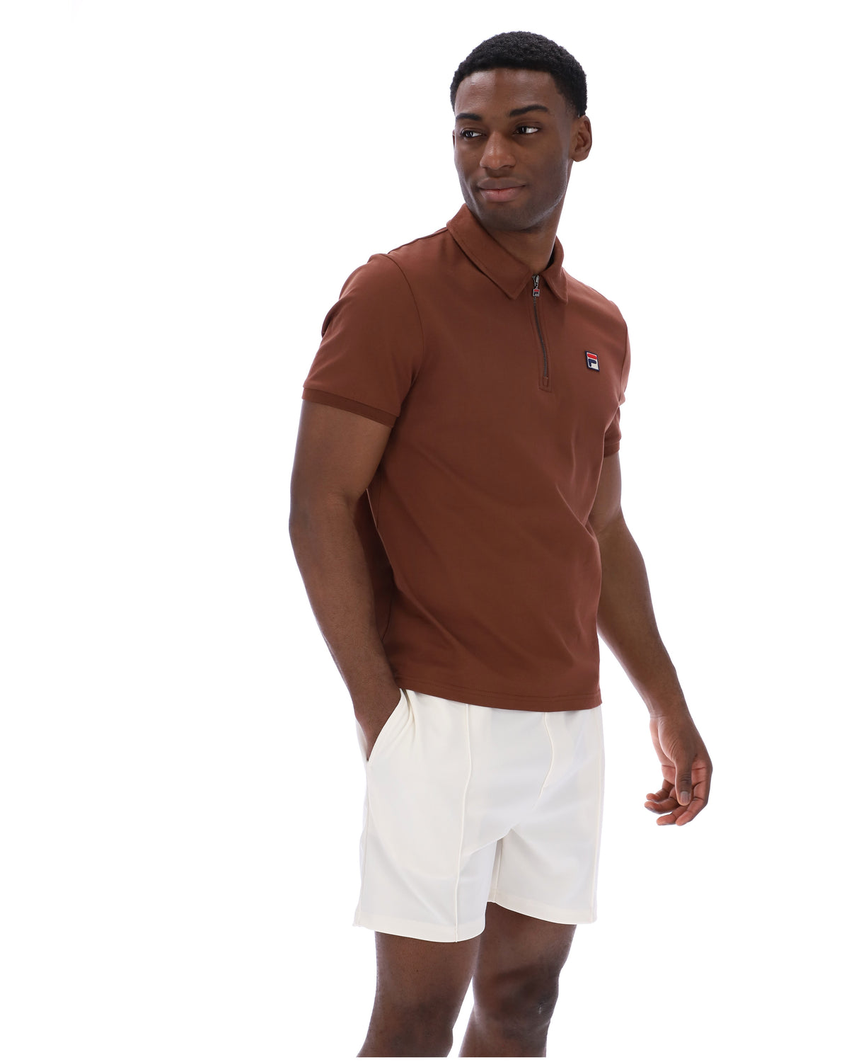 Man wearing a brown polo shirt and white shorts on a white background