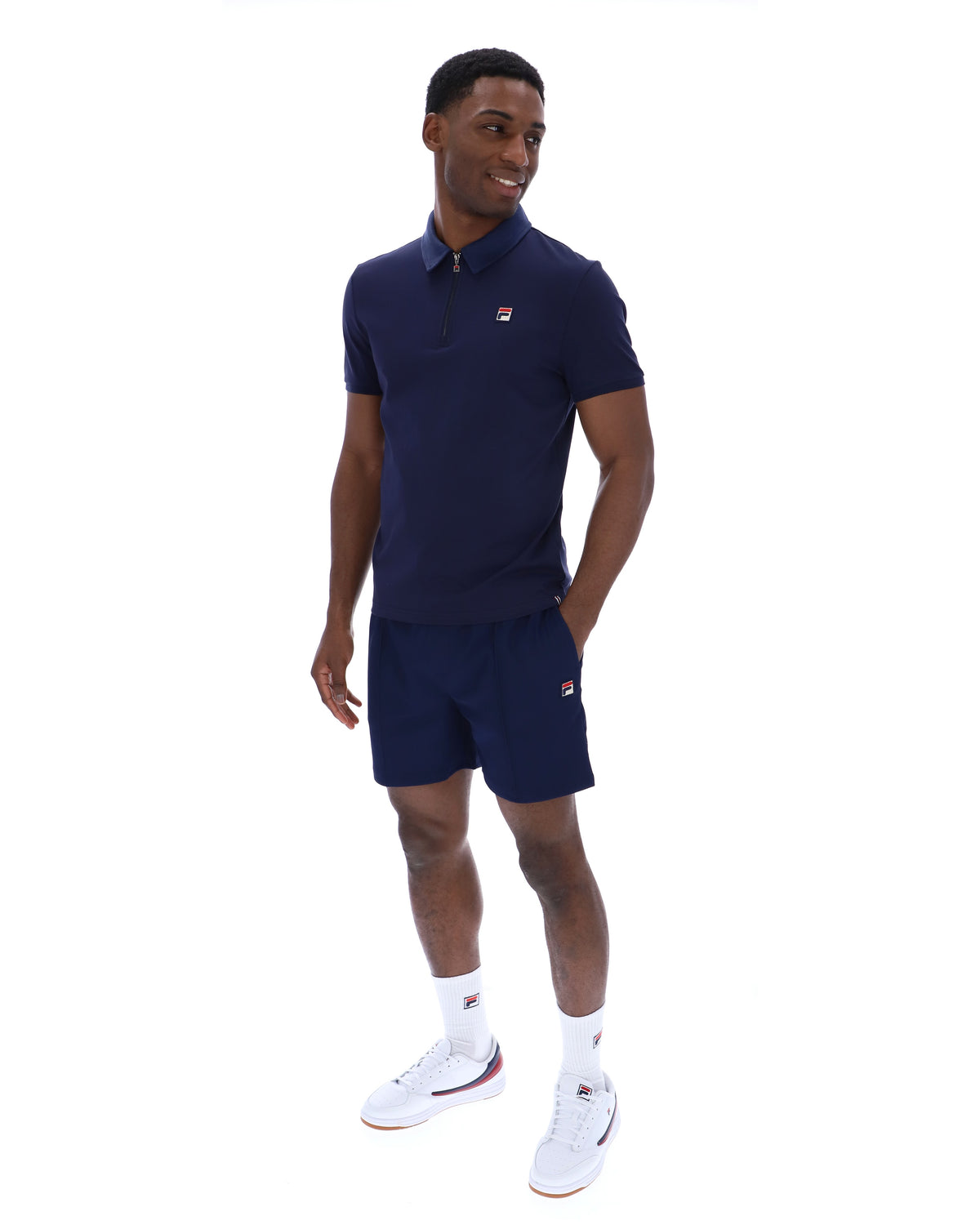 Displays a model wearing the Navy 'Fila' branded Ettore Zip Polo