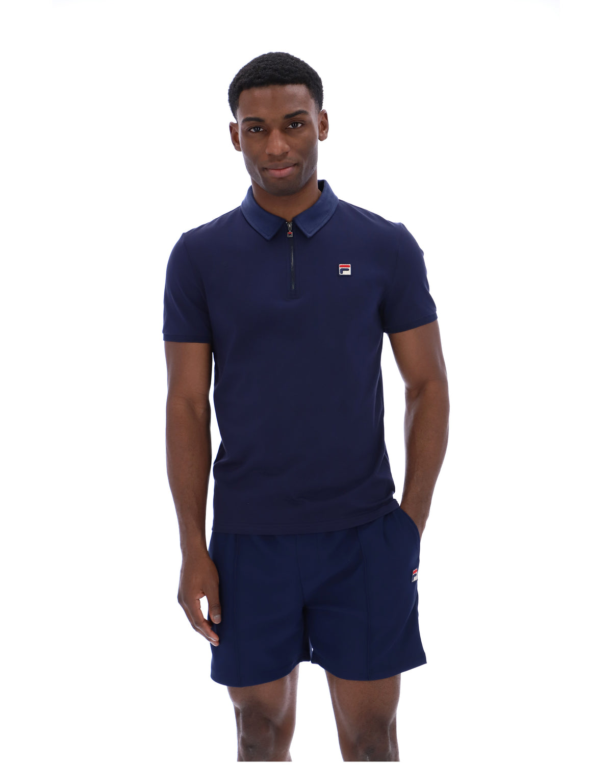Displays a model wearing the Navy 'Fila' branded Ettore Zip Polo