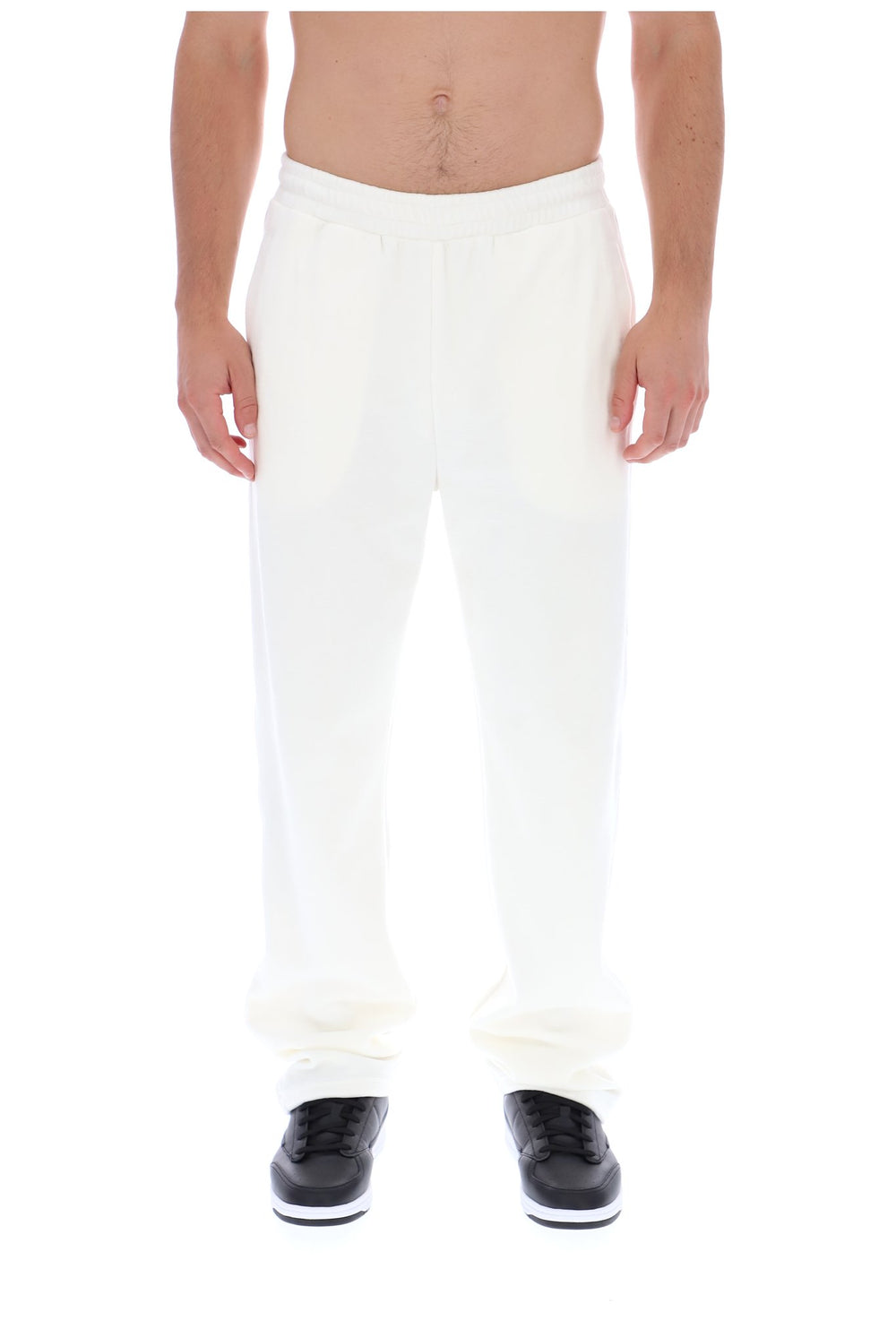 Displays a model wearing the White 'FILA' branded Down Fario Velour Track Pant
