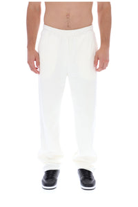 Displays a model wearing the White 'FILA' branded Down Fario Velour Track Pant