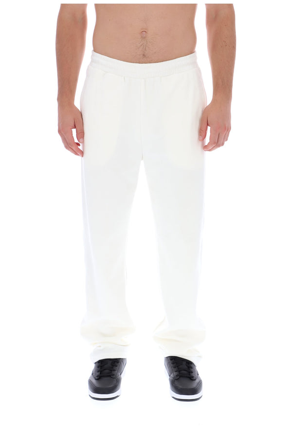 Displays a model wearing the White 'FILA' branded Down Fario Velour Track Pant