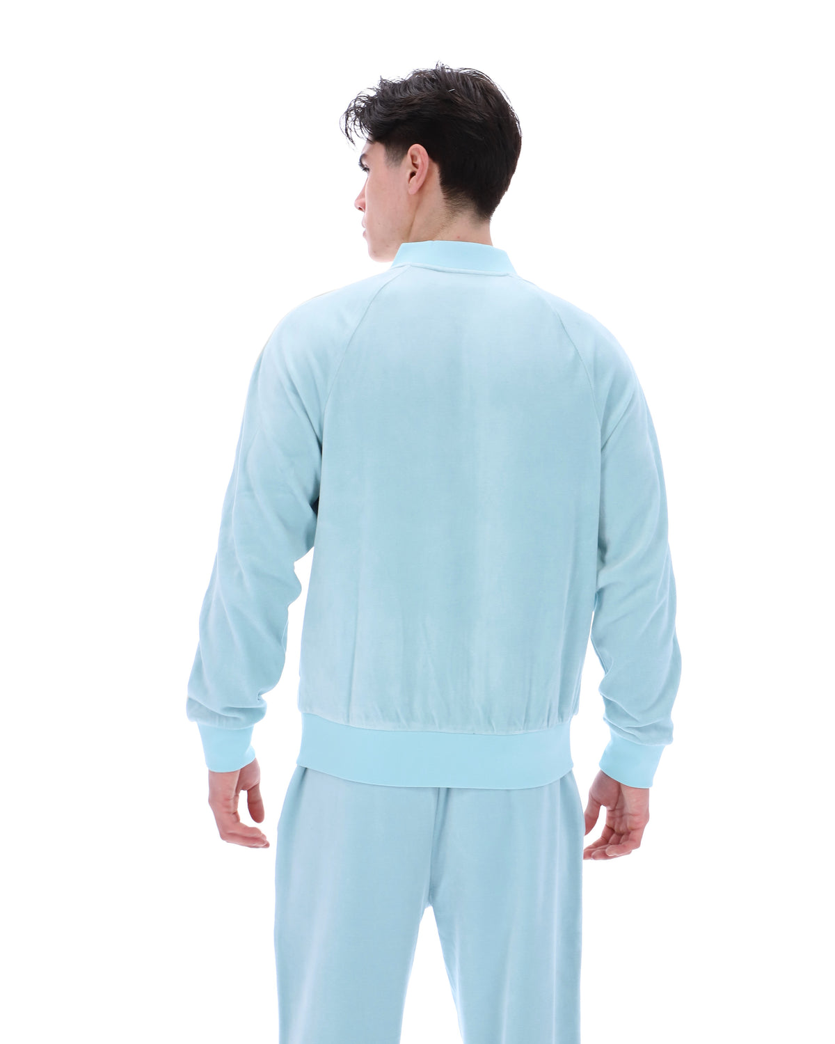 Person wearing a light blue tracksuit on a white background