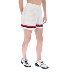 Displays a model wearing the Fino 'FILA' branded Knitted Crochet Shorts