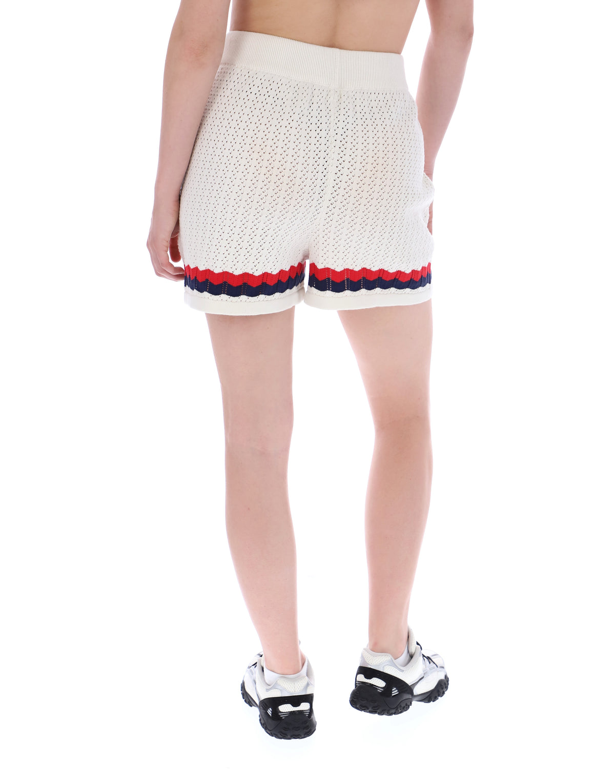 Displays a model wearing the Fino 'FILA' branded Knitted Crochet Shorts
