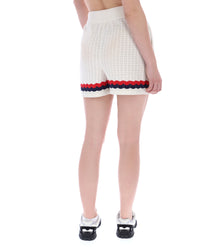 Displays a model wearing the Fino 'FILA' branded Knitted Crochet Shorts