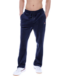 Navy blue sweatpants with a FILA logo, worn by a person on a white background