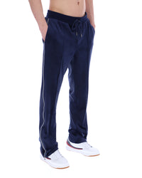Navy blue track pants with white stripes on a white background