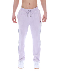 Displays the model wearing the Misty Lilac 'FILA' branded Fio Velour Straight-Leg Jogger