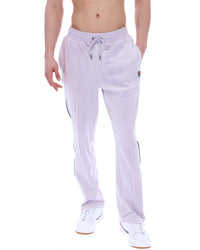 Displays the model wearing the Misty Lilac 'FILA' branded Fio Velour Straight-Leg Jogger