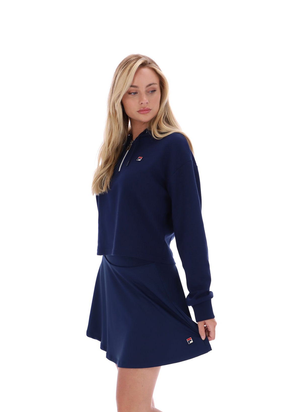 Displays a model wearing the Navy 'FILA' branded Fiorella 1/4 Zip Up Hoodie
