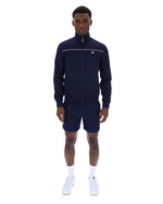 Man wearing a navy tracksuit with a white logo on a white background