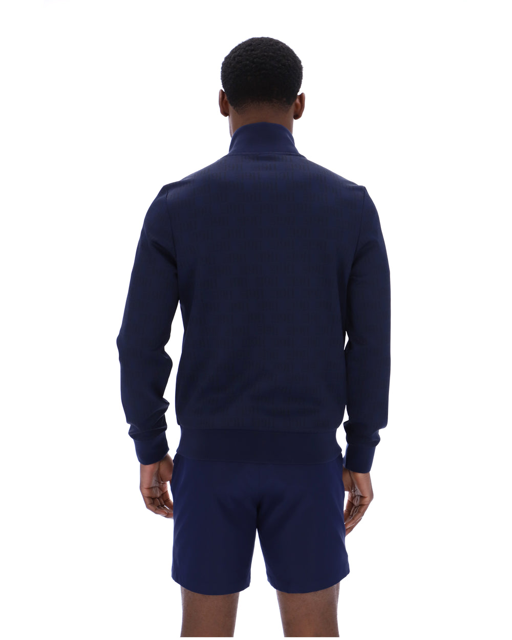 Person wearing a navy blue tracksuit on a white background