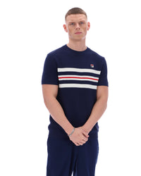Man wearing a Navy blue t-shirt with white and red stripes and Fila logo with matching joggers on a white background