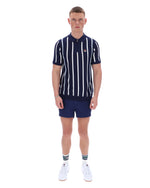 Man wearing a navy and white striped polo shirt with matching shorts on a white background