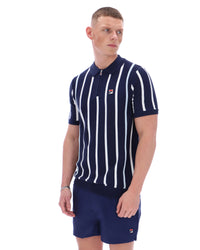 Man wearing a navy and white striped polo shirt with matching shorts on a white background