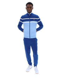 Displays a model wearing the Frozen Fjord 'FILA' branded Giovanni Contrast Panels Track Top