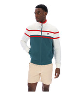 Man wearing a green and white track top with red detailing, with a FILA logo on the chest, paired with beige FILA shorts, against a white background