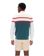 Person wearing a colorful striped sweater with a white background
