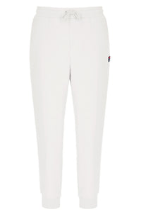 White jogger pants with a small FILA logo on a white background