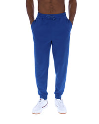 Blue sweatpants worn by a person on a white background