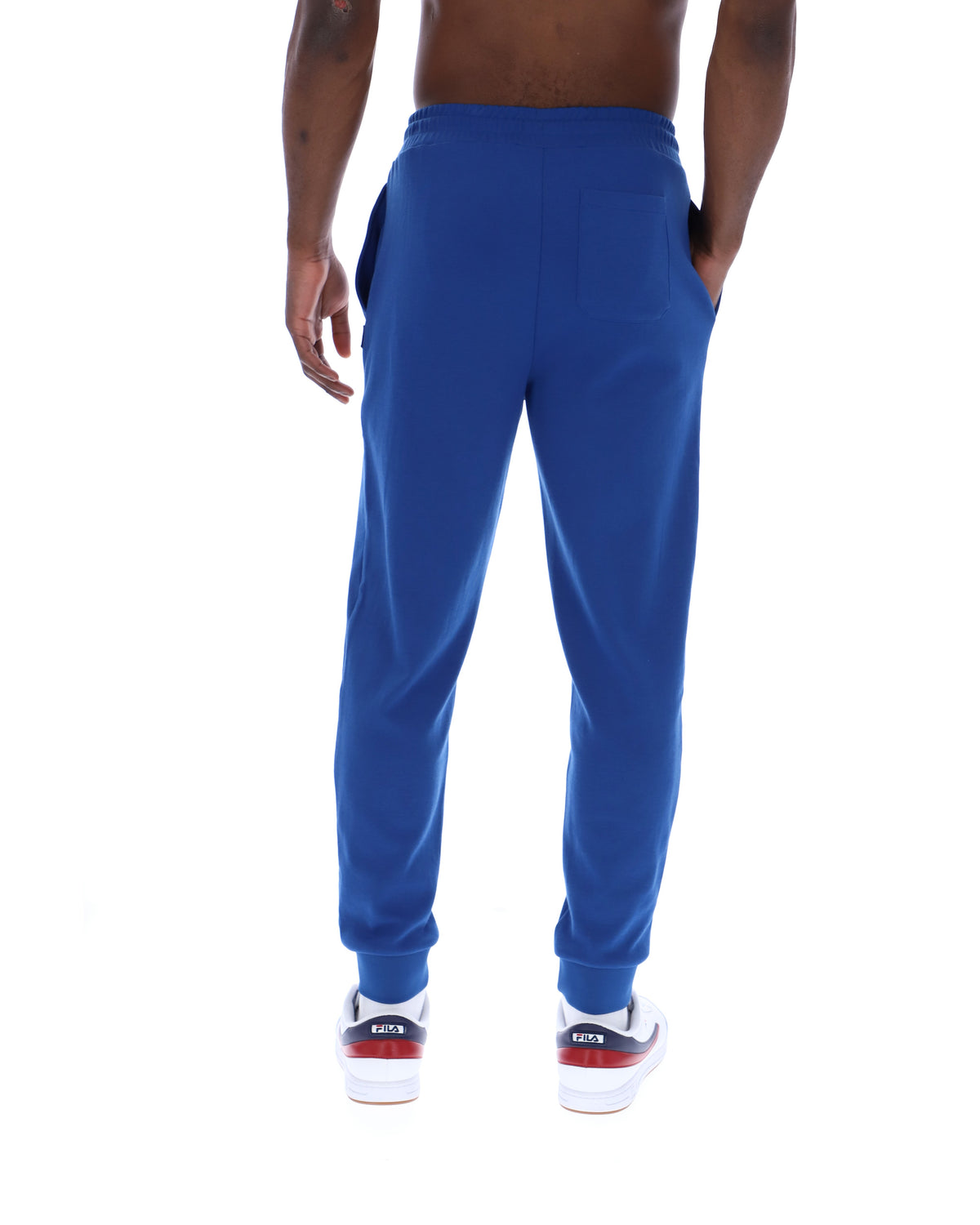 Blue sweatpants worn by a person on a white background