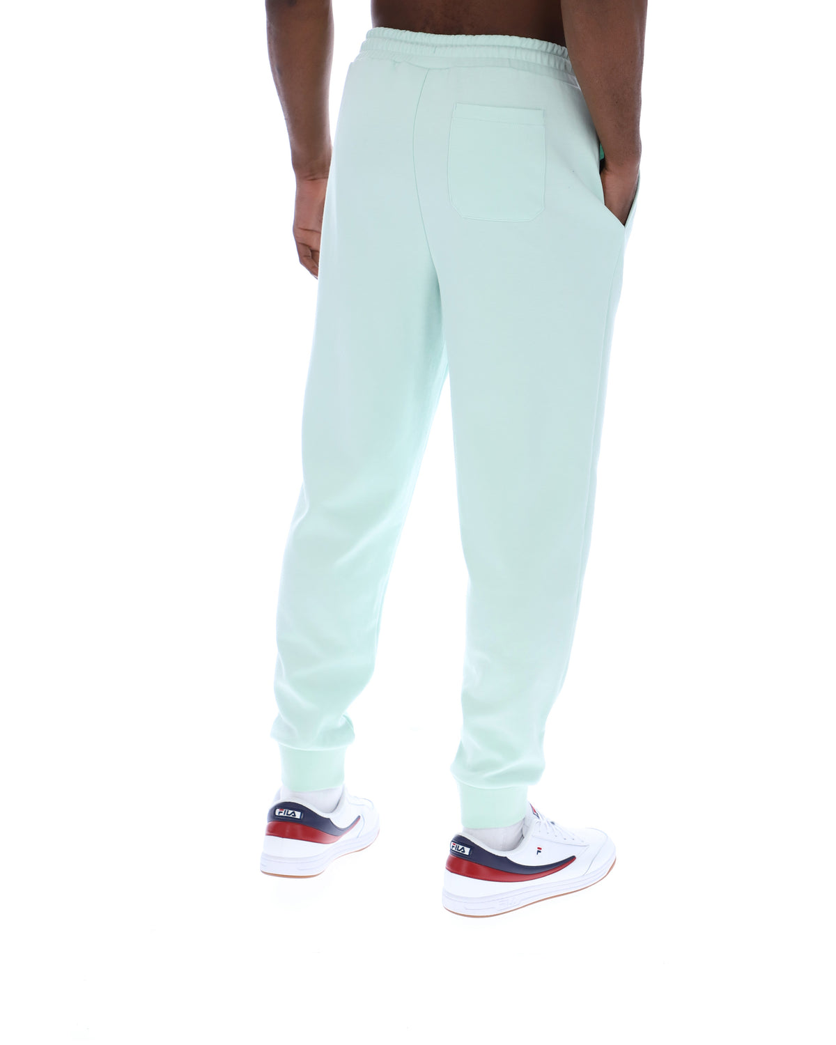 Light blue sweatpants worn by a person on a white background