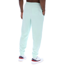 Light blue sweatpants worn by a person on a white background