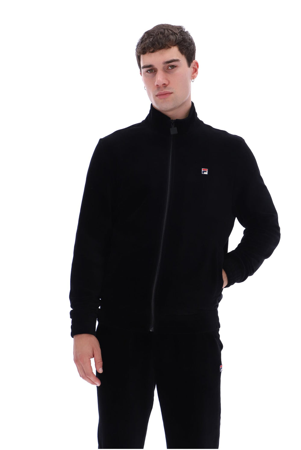 A man wearing a black zip-up fleece jacket and matching black sweatpants with a small red, white, and blue Filson logo on the chest, photographed against a solid white background.