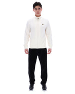 Man wearing a white jacket and black pants on a white background