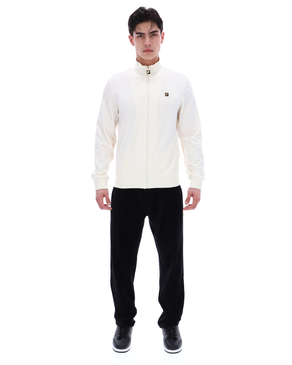 Man wearing a white jacket and black pants on a white background